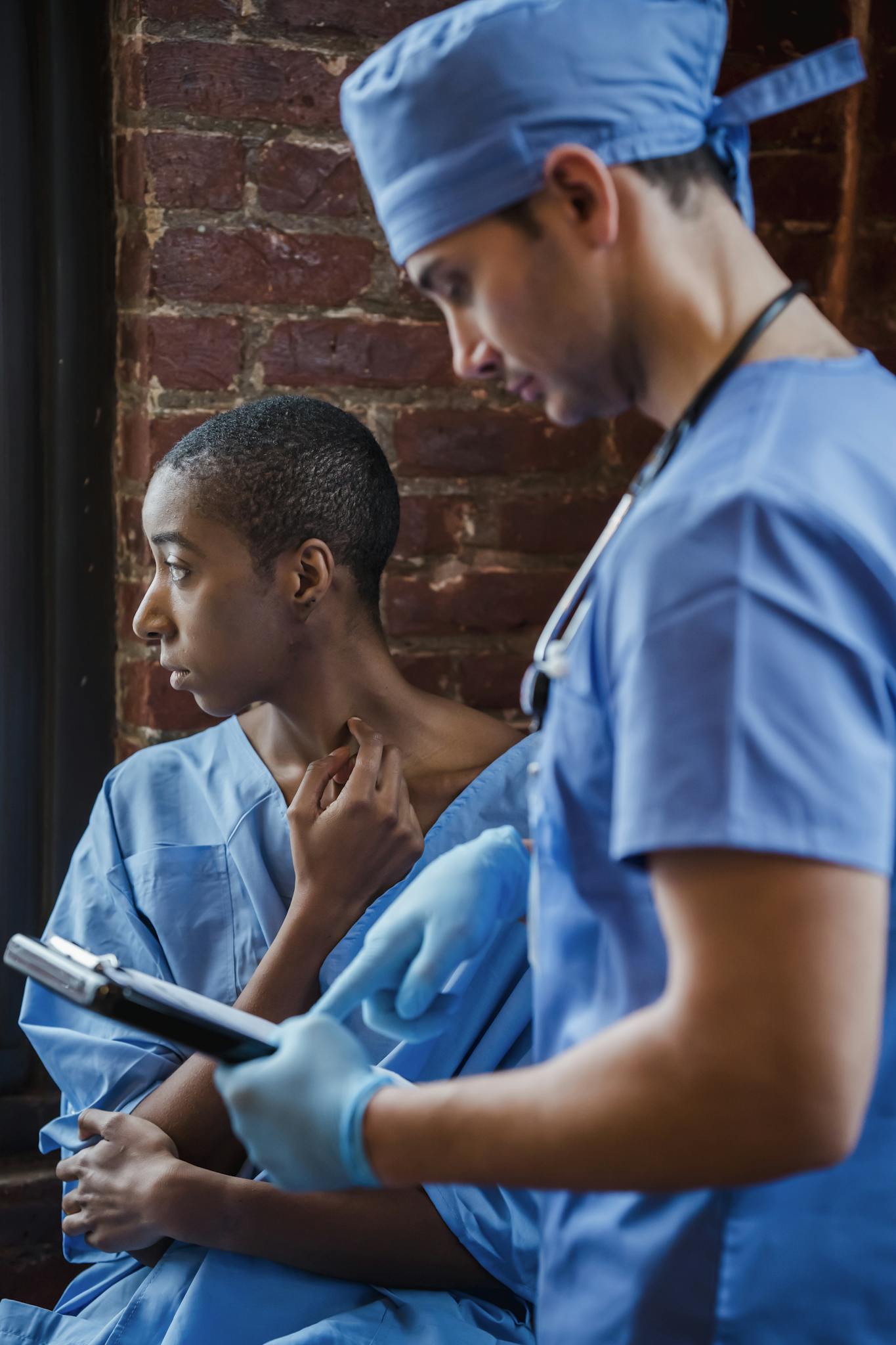 Doctor consulting a patient in a hospital corridor, discussing medical care.